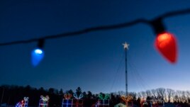 Holiday lights are displayed on a drive-thru route at the Cumberland Fair Grounds, Tuesday, Dec. 14, 2021, in Cumberland, Maine. (AP Photo/Robert F. Bukaty)