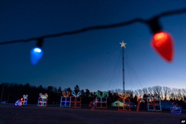 Holiday lights are displayed on a drive-thru route at the Cumberland Fair Grounds, Tuesday, Dec. 14, 2021, in Cumberland, Maine. (AP Photo/Robert F. Bukaty)