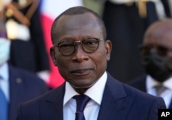 FILE—Benin President Patrice Talon listening to French President Emmanuel Macron after a sining ceremony at the Elysee Palace in Paris, November 9, 2021.