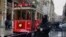 A tram drives past a Turkish police officer as he patrols central Istanbul's Istiklal Avenue, the main shopping road of Istanbul, Jan. 5, 2017.