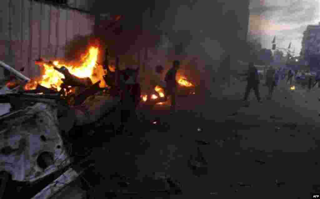 Palestinians gather around a destroyed car after an explosion in Gaza City, Wednesday, Nov. 17, 2010. Hamas officials say one person has been killed and four others wounded in a car explosion in the Gaza Strip. Hamas media reported the car was hit in an a