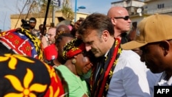 France&#39;s president Emmanuel Macron embraces a woman as he speaks with local residents during his visit at the kavani district in Mamoudzou, on the French Indian Ocean territory of Mayotte, aftermath of the cyclone Chido.