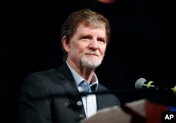 FILE - Jack Phillips, owner of Masterpiece Cake, speaks during a rally on the campus of a Christian college in Lakewood, Colo., Nov. 8, 2017. The small rally was held to build support for Phillips, who is at the center of a case considered by the U.S. Supreme Court in December. 2017.