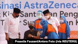 Seorang santri Pesantren Lirboyo sedang disuntik vaksin COVID-19 buatan AstraZeneca, di Kediri, Jawa Timur, 23 Maret 2021. (Foto: Prasetia Fauzani/Antara Foto via Reuters) 