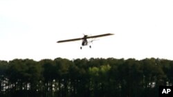 Ray Gefken takes flight in his ultralight, single-seat airplane. (Mary Saner/VOA)