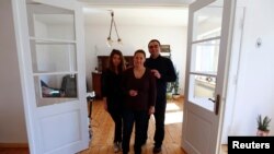 Jozef Walukiewicz, his wife Anna and daughter Katarzyna stand inside their renovated house in the village of Rosow, Germany, located near the Polish border, April 7, 2013.