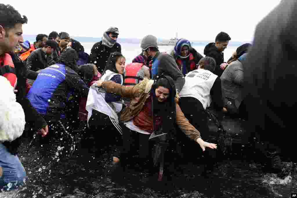 Migrants arrive with a dinghy at the village of Skala Sikaminias, on the Greek island of Lesbos, after crossing the Aegean sea from Turkey. 