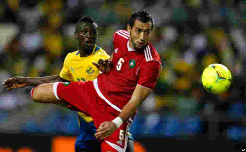 Morocco's Amine fights for the ball with Gabon's Charly during their African Cup of Nations soccer match in Libreville