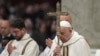 Pope Francis holds the cross as he presides over an Epiphany mass in St. Peter's Basilica at the Vatican, Jan. 6, 2025. Francis named an Italian nun, Sister Simona Brambilla, to head a major Vatican office.