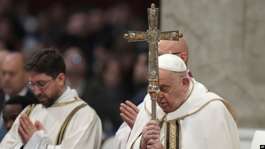 Pope Francis holds the cross as he presides over an Epiphany mass in St. Peter's Basilica at the Vatican, Jan. 6, 2025. Francis named an Italian nun, Sister Simona Brambilla, to head a major Vatican office.