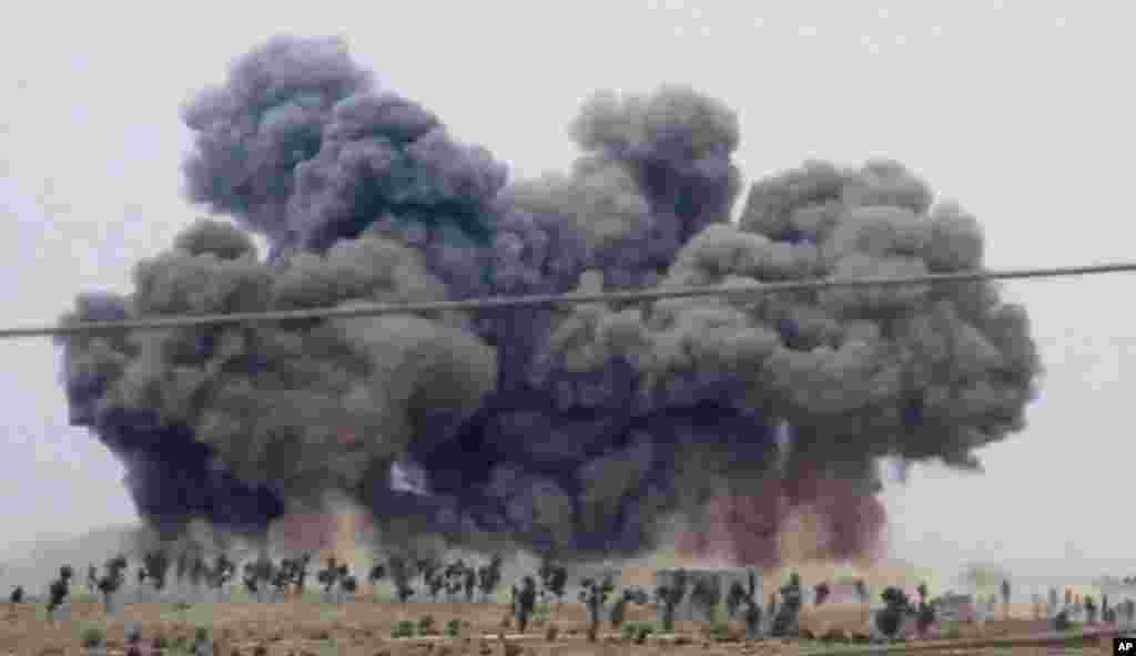 In this image made from video provided by Hadi Al-Abdallah, which has been verified and is consistent with other AP reporting, smoke rises after airstrikes in Kafr Nabel of the Idlib province, western Syria. Russian jets carried out a second day of airstrikes in Syria, but there were conflicting claims about whether they were targeting Islamic State and al-Qaeda militants or trying to shore up the defenses of President Bashar Assad.