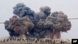 FILE - In this image made from video provided by Hadi Al-Abdallah, which has been verified and is consistent with other AP reporting, smoke rises after airstrikes in Kafr Nabel of the Idlib province, western Syria, Oct. 1, 2015. 