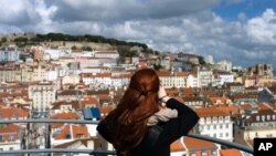 A woman takes pictures from the top of Lisbon's Santa Justa lift, April 19 2016.