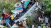 This handout photograph taken and released on Nov. 4, 2024, by the Department of Information and Public Relations Uttarakhand shows people at the site of a bus accident, after it fell into a gorge at Almora district in India's Uttarakhand state.