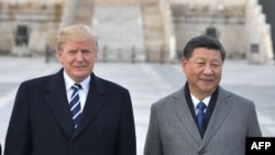 In this file photo taken on Nov. 8, 2017, U.S. President Donald Trump and Chinese President Xi Jinping pose at the Forbidden City in Beijing. 