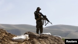 FILE - An Afghan National Army (ANA) soldier keeps watch during a patrol in Dand Ghori district of Baghlan province, Afghanistan. March 15, 2016. 
