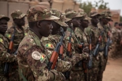 A Malian soldier wears the insignia of the Malian army and the Barkhane operation during the handover ceremony of the Barkhane military base from the French to the Malian army in Timbuktu, Dec. 14, 2021.