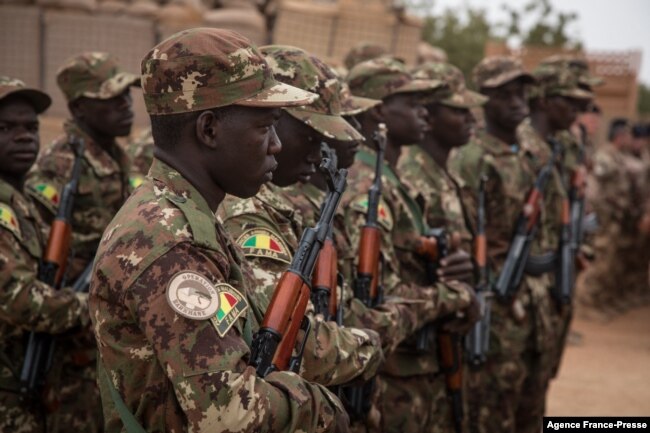 A Malian soldier wears the insignia of the Malian army and the Barkhane operation during the handover ceremony of the Barkhane military base from the French to the Malian army in Timbuktu, Dec. 14, 2021.