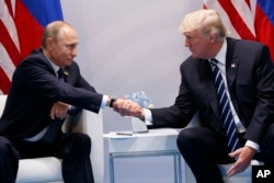President Donald Trump shakes hands with Russian President Vladimir Putin at the G-20 Summit, July 7, 2017, in Hamburg, Germany.