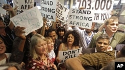 Protesters shout as they demonstrate at the climate change conference in Durban, South Africa, December 9, 2011.