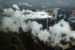 FILE PHOTO - In this Nov. 28, 2019 photo, smoke and steam rise from a coal processing plant in Hejin in central China's Shanxi Province.