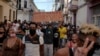 People walk down one of the main streets of Havana, Cuba, chanting anti-government slogans on July 11, 2021. 