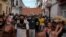 People walk down one of the main streets of Havana, Cuba, chanting anti-government slogans on July 11, 2021. 