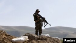 FILE - An Afghan National Army (ANA) soldier keeps watch during a patrol in Dand Ghori district of Baghlan province, Afghanistan. March 15, 2016. 