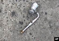 This photo provided by the New York Police Department shows a metal object at the scene where police officers fatally shot a man who was reported to be threatening people with a gun, which turned out to be a metal pipe that police mistook for a firearm.