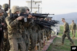 FILE - Marine Corps recruits train at the Edson Firing Range in northern San Diego County, California.