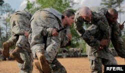 FILE - Soldiers, including a woman, participate in combatives training during the Ranger Course on Fort Benning, Georgia, April 20, 2015.
