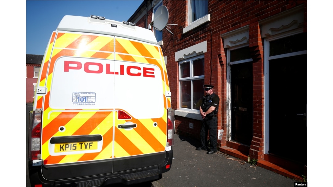 A police officer stand outside a property in Moss Side, following overnight raids in Manchester, Britain, May 25, 2017.