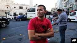 Unemployed Jordanian Hisham al-Halawani, 24, stands on a street in downtown Amman, May 20, 2015.