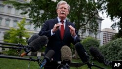 FILE - White House national security adviser John Bolton talks to reporters about Venezuela, in Washington, May 1, 2019.