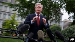 FILE - White House national security adviser John Bolton talks to reporters about Venezuela, in Washington, May 1, 2019.