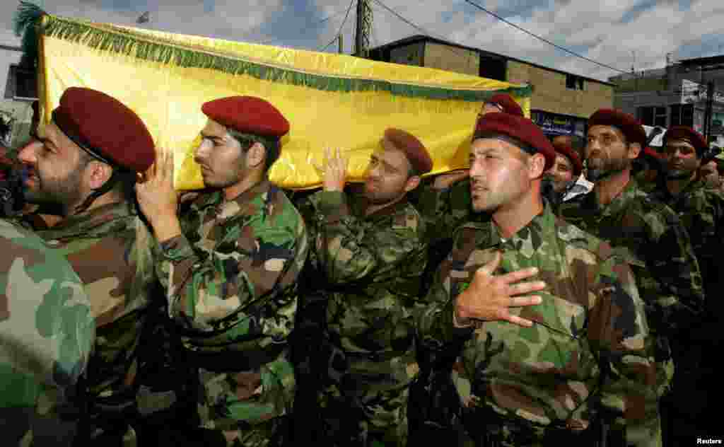 Supporters and relatives of Hezbollah members attend the funeral of a Hezbollah fighter who died in the Syrian conflict. The funeral took place in the Ouzai district in Beirut, May 26, 2013.