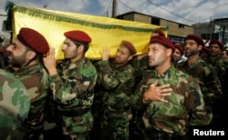 FILE - Hezbollah members attend the funeral of a Hezbollah fighter who died in the Syrian conflict, in Beirut, May 26, 2013. Authorities in Kabul and human rights groups have roundly criticized Iran for sending Afghans living in Iran to Syria to fight alongside Hezbollah and Iranian forces in support of the Assad government.