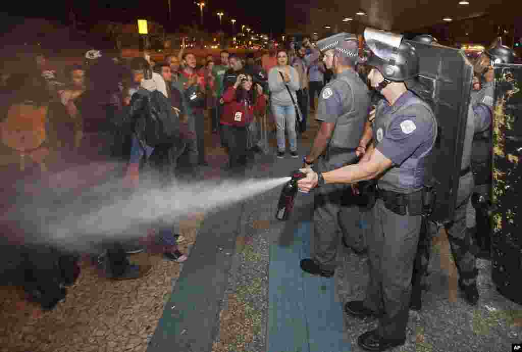 Polisi menyemprotkan gas merica para demonstran dalam bentrokan dengan polisi anti-huru-hara di depan stasiun metro Ana Rosa, di tengah pemogokan operator kereta bawah tanah di Sao Paulo, Brazil (9/6). (AP/Mario Angelo)