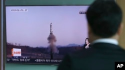 A man watches a TV report about North Korea's missile firing with file footage, at Seoul Train Station in Seoul, South Korea, April 6, 2017. The letters read "U.S., North, Scud missile-ER." 