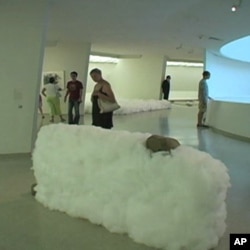 Opposites coexist in these Lee Ufan sculptures where heavy rocks and steel are held in the air by clouds of cotton.