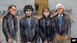 In this courtroom sketch, Dzhokhar Tsarnaev, second from left, is depicted standing with his defense attorneys William Fick, left, Judy Clarke, second from right, and David Bruck, right, as the jury presents its verdict, April 8, 2015.