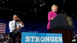 President Barack Obama pretends to wipe away tears as Democratic presidential candidate Hillary Clinton talks about Malia Obama graduating college, during a campaign event at the Charlotte Convention Center in Charlotte, N.C., July 5, 2016.