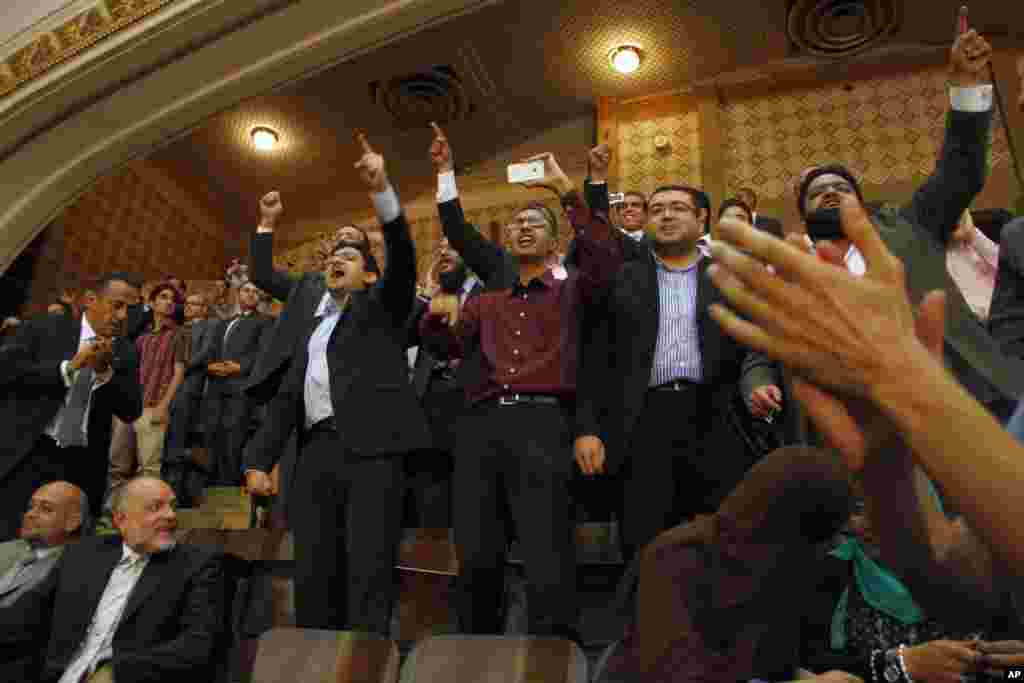 Guests react as Egypt's newly inaugurated President Mohamed Morsi appears at Cairo University in Cairo, Egypt, June 30, 2012.