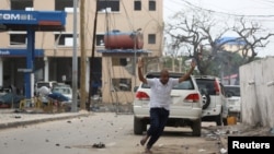 有人逃离摩加迪沙机场附近的一家酒店的自杀炸弹爆炸现场（2016年6月25日）