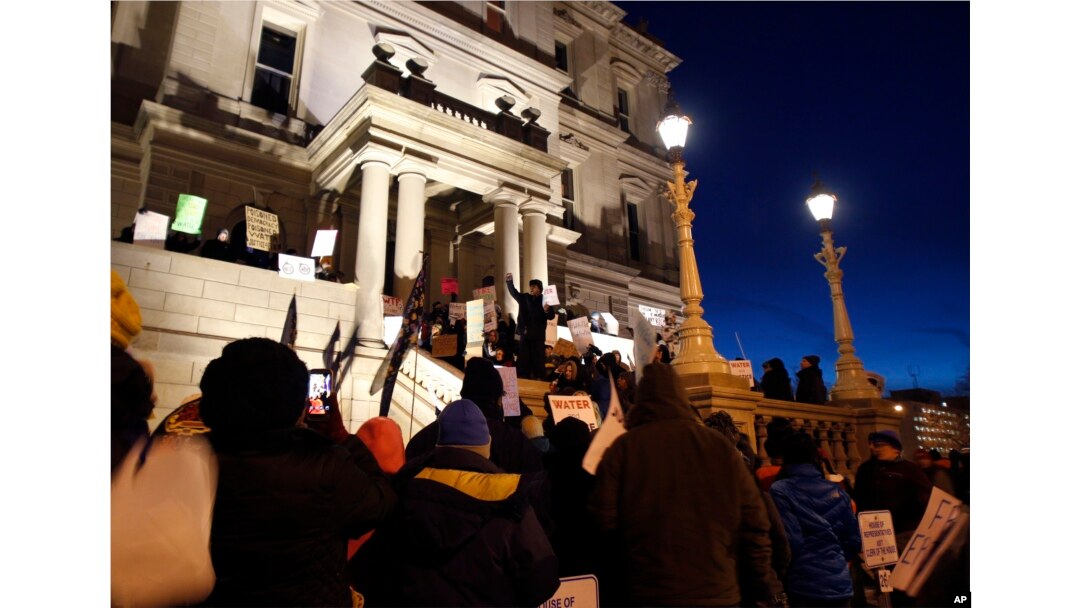With a toxic water crisis gripping the city of Flint, protesters gather outside the Capitol in Lansing, Mich., before Gov. Rick Snyder's State of the State address, Jan. 19, 2016.