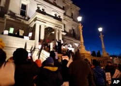 With a toxic water crisis gripping the city of Flint, protesters gather outside the Capitol in Lansing, Mich., before Gov. Rick Snyder's State of the State address, Jan. 19, 2016.