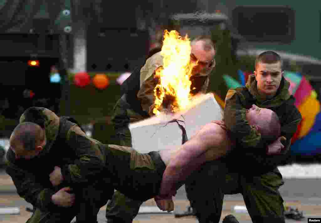 Servicemen of the Belarussian Interior Ministry&#39;s special forces unit perform during Maslenitsa celebrations, a pagan holiday marking the end of winter celebrated with pancake eating and shows of strength, at their base in Minsk, Belarus.