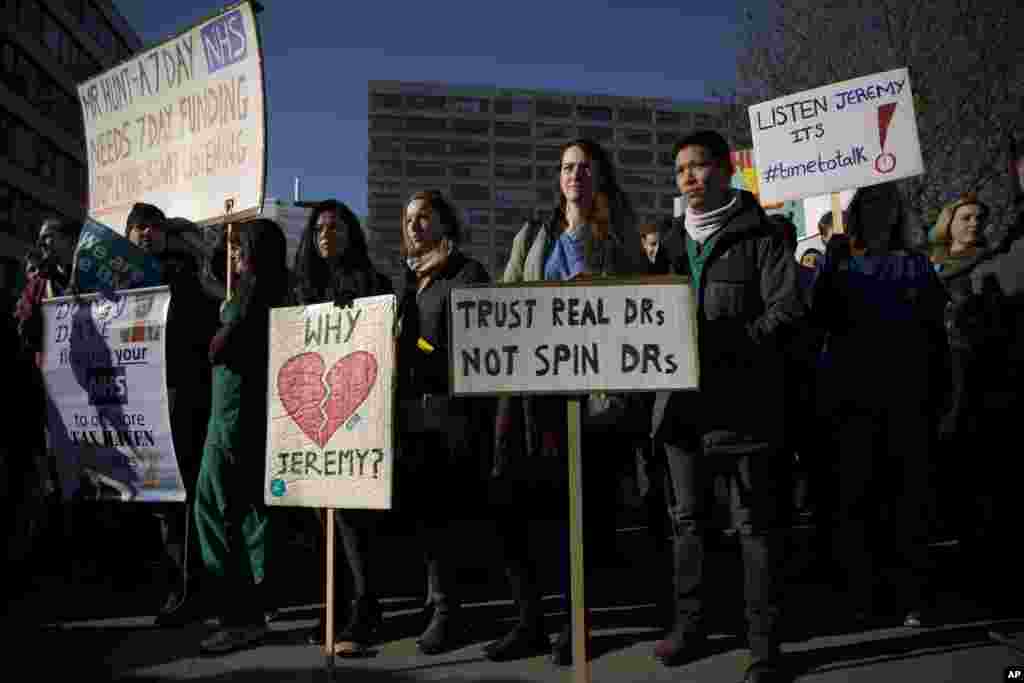 Junior doctors hold placards as they take part in the start of a 48-hour strike on their picket line outside St Thomas&#39; Hospital in London.