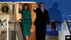 President Donald Trump and first lady Melania Trump wave from Air Force One upon their arrival in Warsaw, Poland, July 5, 2017.