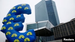 FILE - Inflated euro sign is seen outside the new headquarters of the European Central Bank in Frankfurt, January 2015. 